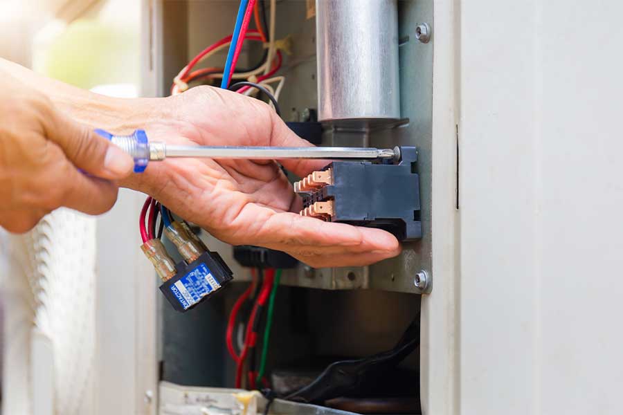 HVAC technician performing furnace maintenance in St. Charles